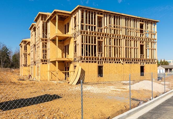 a job site enclosed by temporary chain link fences, ensuring safety for workers and pedestrians in Hobe Sound